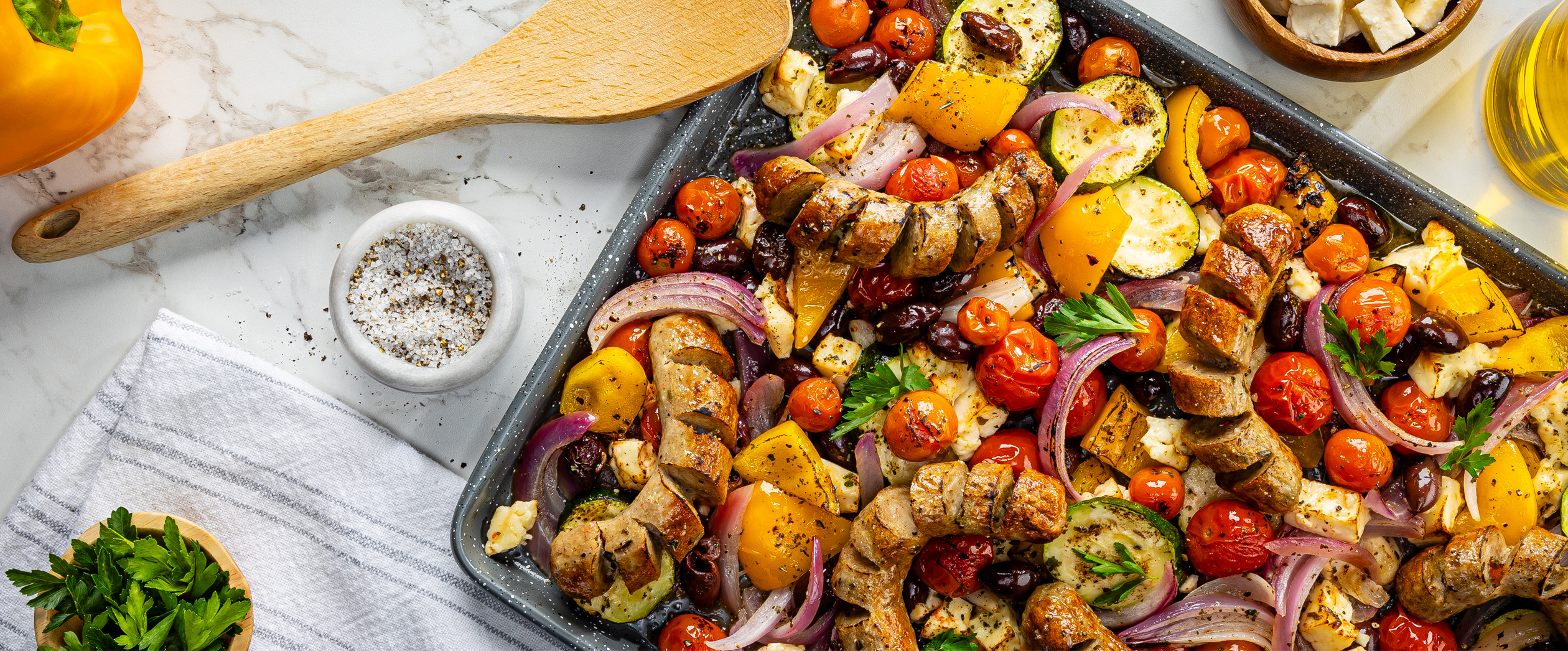 Al Fresco Greek Sheet pan dinner on a counter featuring Italian Chicken Sausage